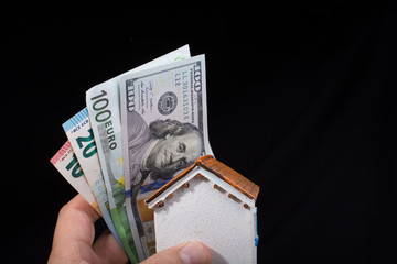 Hand holding American dollar  isolated on black background