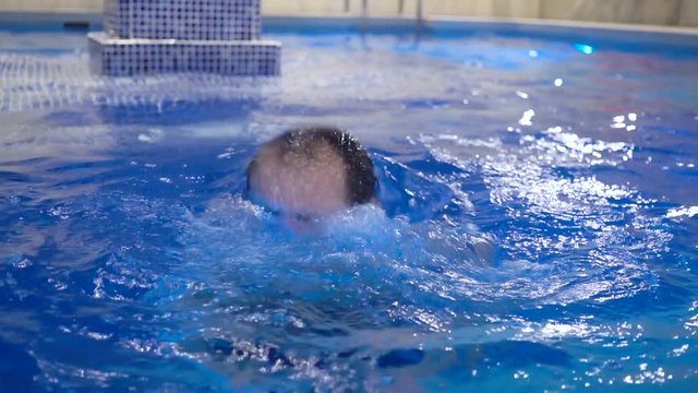 Man relaxing in swimming pool