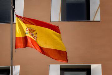 Flag of Spain waving on a pole.