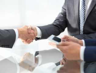 Two confident businessmen shaking hands during a meeting in the