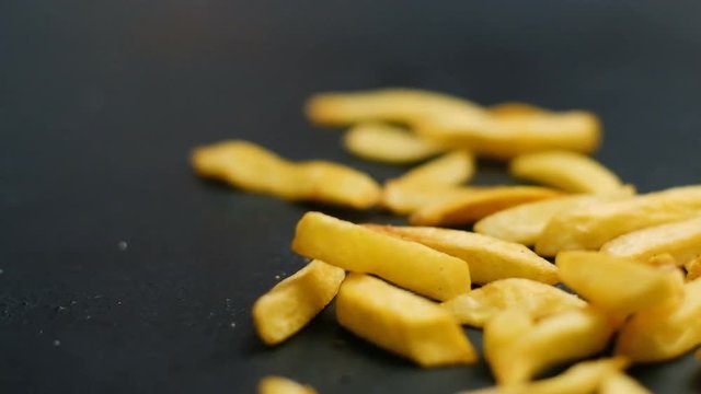 french fries falling on the surface. fast food chips fattening diet. unbalanced eating