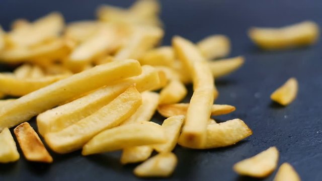 french fries chips drop on the surface. fast food and unhealthy nutrition. junk meal. trans fats and carbs