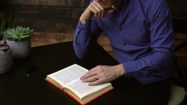 Man reading a hardcover book