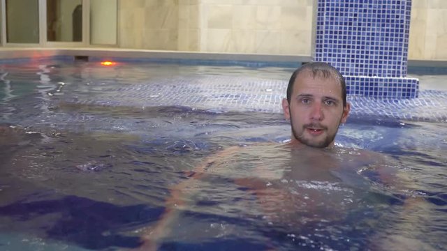 Man relaxing in swimming pool