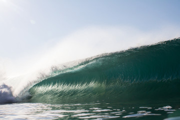 close up of a breaking wave on a tropical reef
