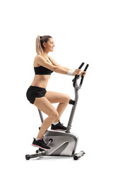 Young woman exercising on a cross trainer machine