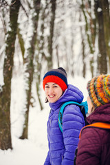 Two women are walking in the park.