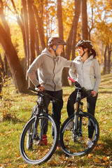 Fototapeta na wymiar backlight photo of a couple having fun by bike