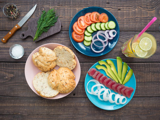 Sandwich with tuna on a plate, vegetables and a glass of lemonade