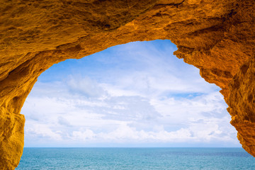 View to the sea and sky from inside a cave