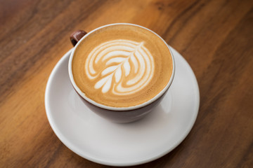 Single cup of coffee with artistic foam display