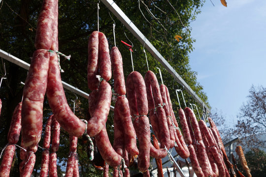 The suspended pieces of the meat drying outside