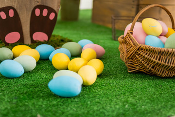 Happy Easter. Colorful Easter eggs in wicker basket. Spring holiday concept. Hand painted Easter eggs.Springtime decoration for home.Selective focus. Copy space