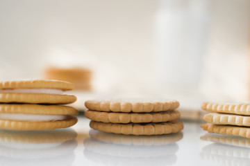 A round cookie with white filling on a light background