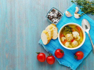 Delicious, thick Soup with Turkey meatballs and mixed vegetables - cauliflower, broccoli, carrots, potatoes, garlic, tomatoes.  Copy space, top view