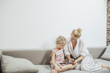 Mother and daughter Enjpoying at Home