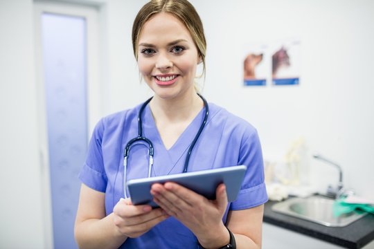 Portrait of vet using digital tablet