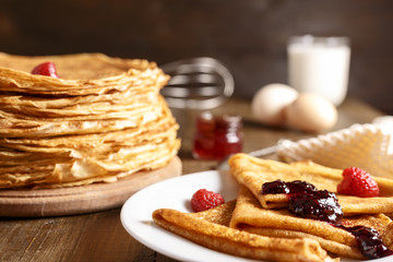 Thin pancakes on a table and on a plate