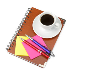 Notebook and cup of coffee isolated on white background. Free space for text.