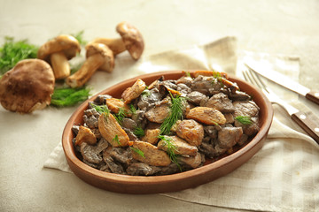 Plate with delicious mushrooms and meat on table