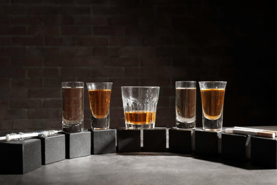 Alcohol and wooden cubes on table