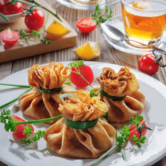 Pancakes with meat, tied with green onions