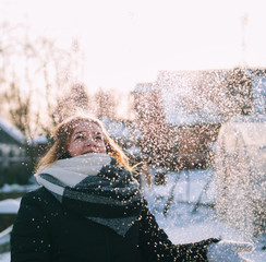 A young woman enjoys the snowfall