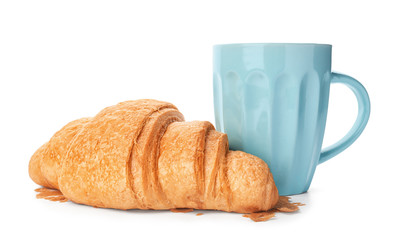 Tasty croissant and cup on white background