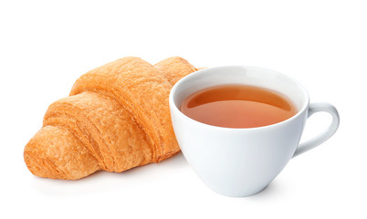 Tasty croissant and cup of tea on white background