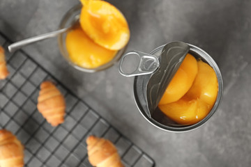 Can with pickled apricots on table