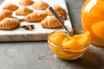 Bowl with pickled apricots on table