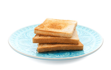 Plate with toasted bread on white background