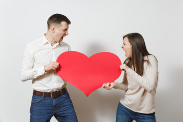 Young couple in love. Man and woman with bir red heart isolated on white background. St. Valentine's Day, International Women's Day, birthday, holiday concept. Quarrel divorce break up of relationship