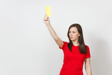 European serious severe young woman, football referee in red uniform show yellow soccer card,...