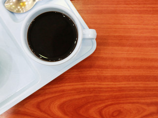 black coffee in white cups on wood wallpaper.