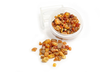 Natural amber. Pieces of amber in the bank and a bunch on a white background. Illustration of how the mineral is mined. Frozen resin in a glass jar. Color amber. The composition of natural stones