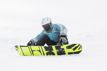 Fototapeta na wymiar .snowboarder sitting on a hillside high mountain