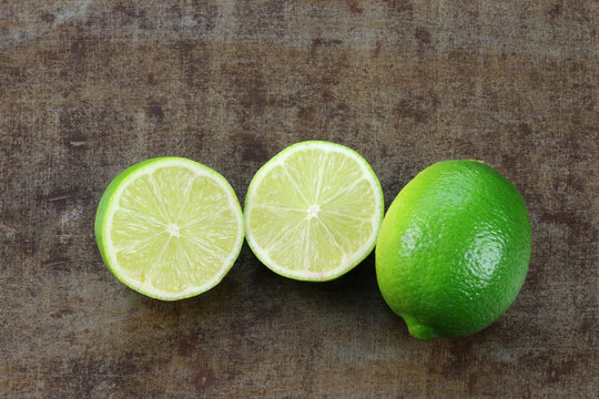 lime fruit and a cut one on a grunge background