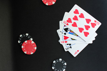 Poker concept on black background. Chips and cards "Street" on the table