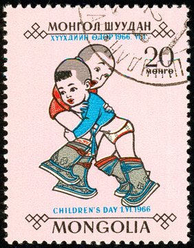 Ukraine - around 2018. The postage stamp printed in Mongolia shows playing children. The Mongolian traditional sport is wrestling. Series: Day of the child. Circa 1966.