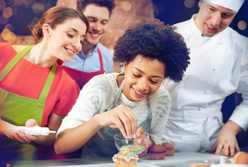 happy friends and chef cook baking in kitchen