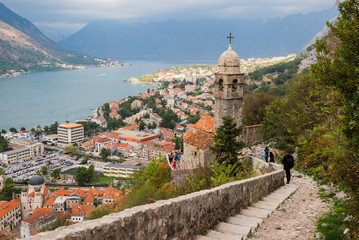 Kotor, Montenegro - 6 October 2017: People walking on path to Kotor Castle of San Giovanni. You can see Kotor Old Town and Church of Our Lady of Remedy  in Kotor, Montenegro.