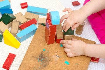 Child playing with old building blocks