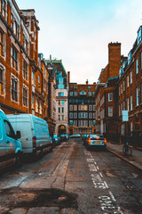 Fototapeta na wymiar lone street in london with orange colored houses