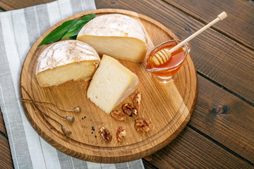 Tasty cheese, honey and nuts. The concept is healthy food, restaurant, cafe, vegetarianism.