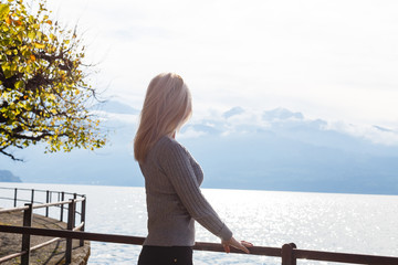 the girl looks to the distant sea and mountains, spring