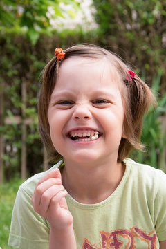 A girl eats popcorn and laughs