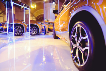 fashionable bright auto show A number of new cars parked in the car dealers' warehouse, modern design of the room with mirrors