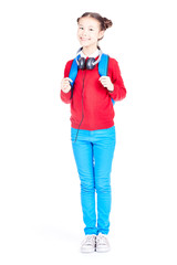 Portrait of Asian school girl posing on white background with backpack and headphones around her neck