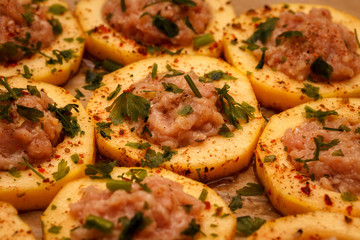Sliced fresh slices of zucchini, filled with minced meat, on food paper. Food Background